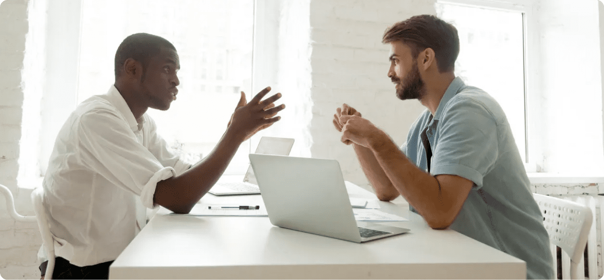 Two men discussing at a table