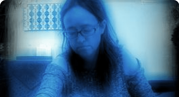 Person sitting in a blue-tinted room