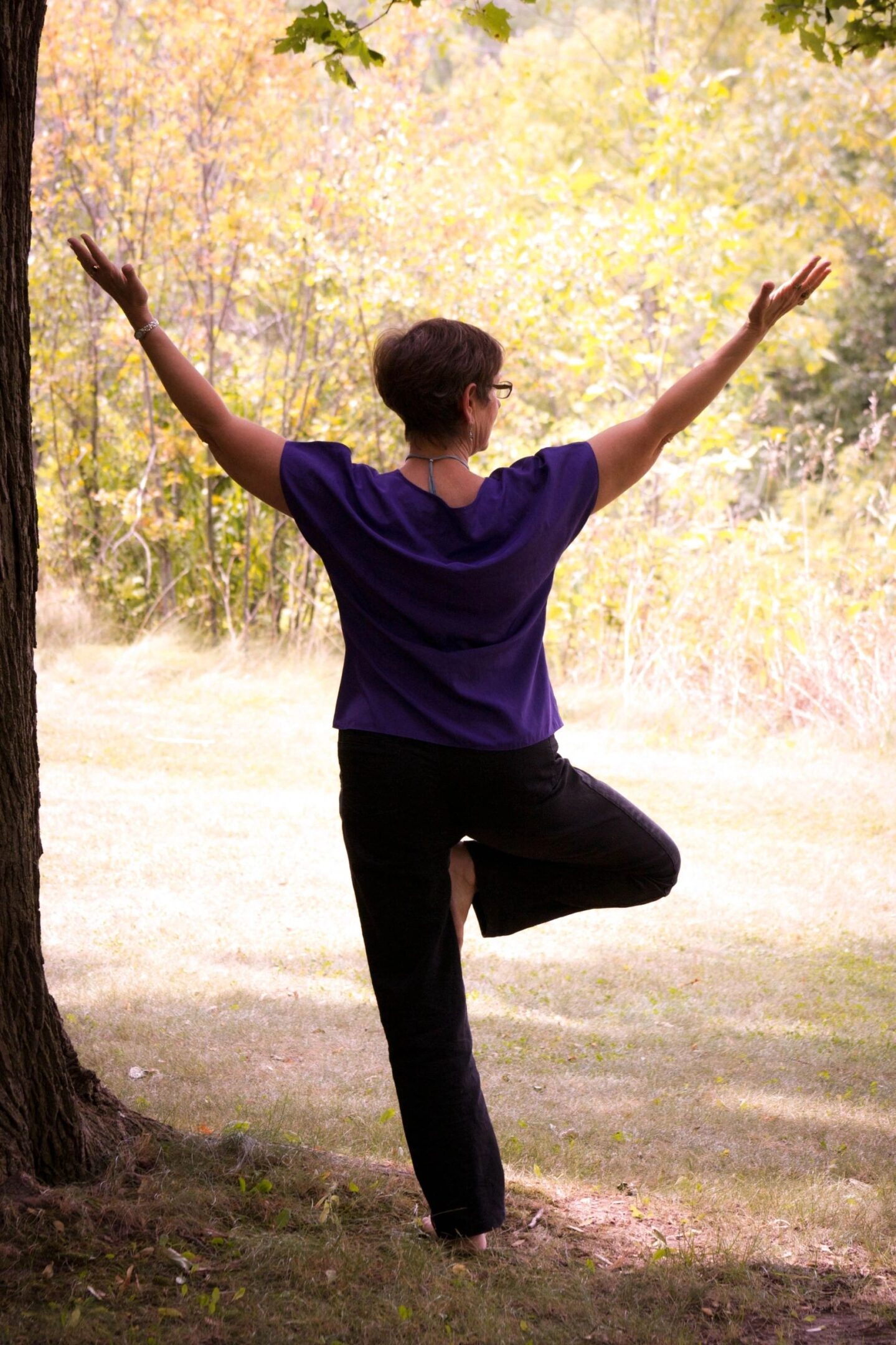 Woman in tree pose outside